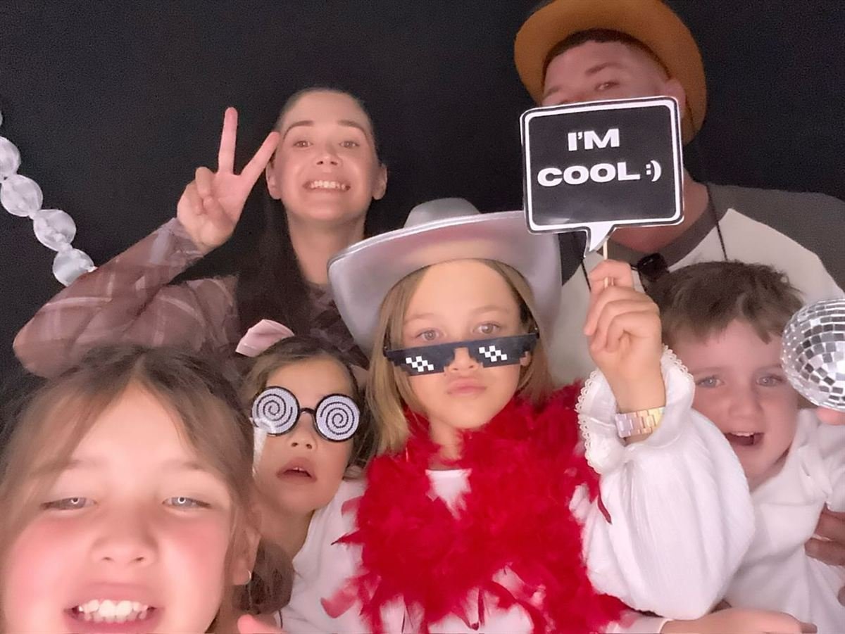 Guests with props at a Perth birthday party photo booth