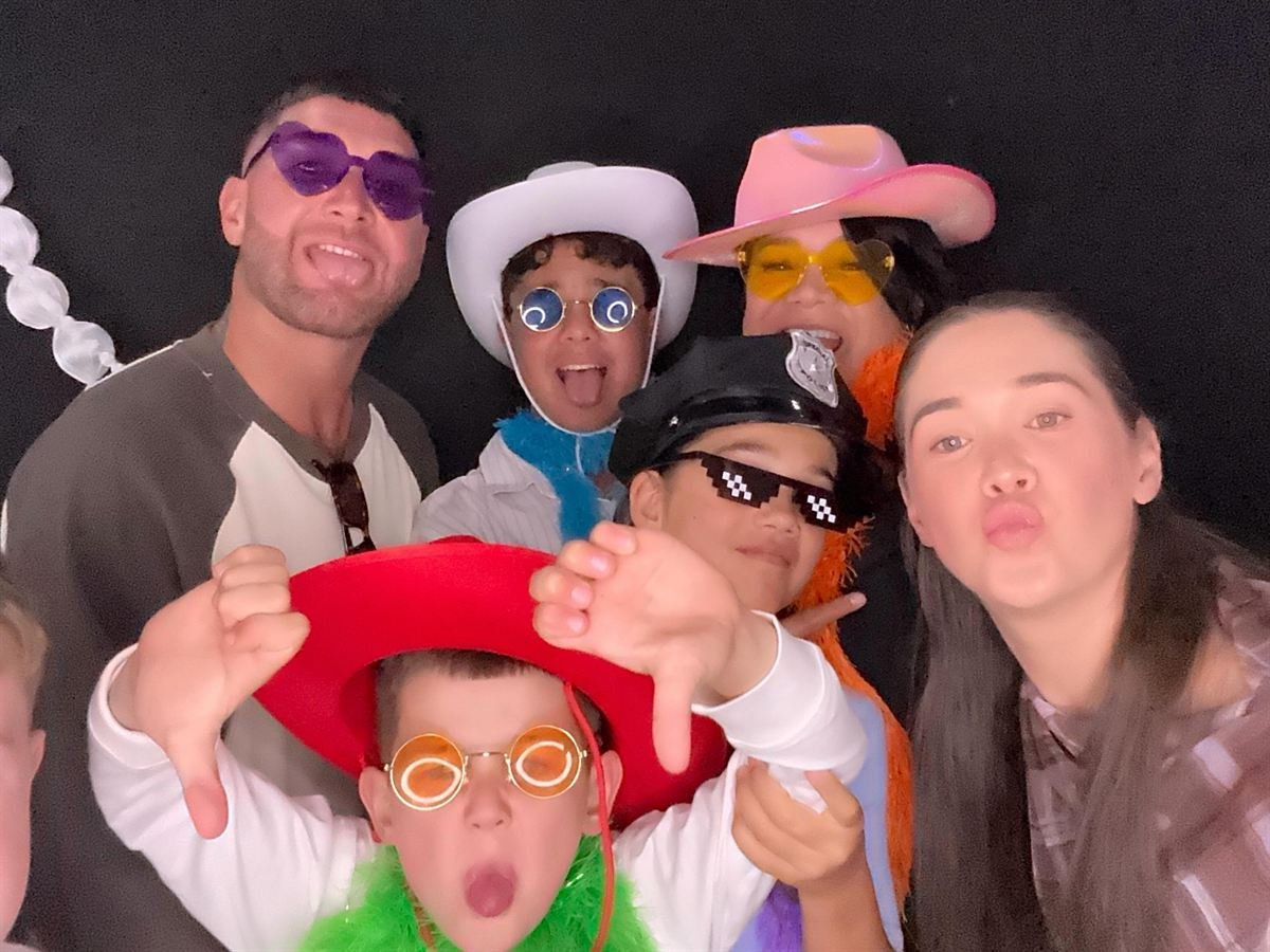 Guests with props at a Perth birthday party photo booth