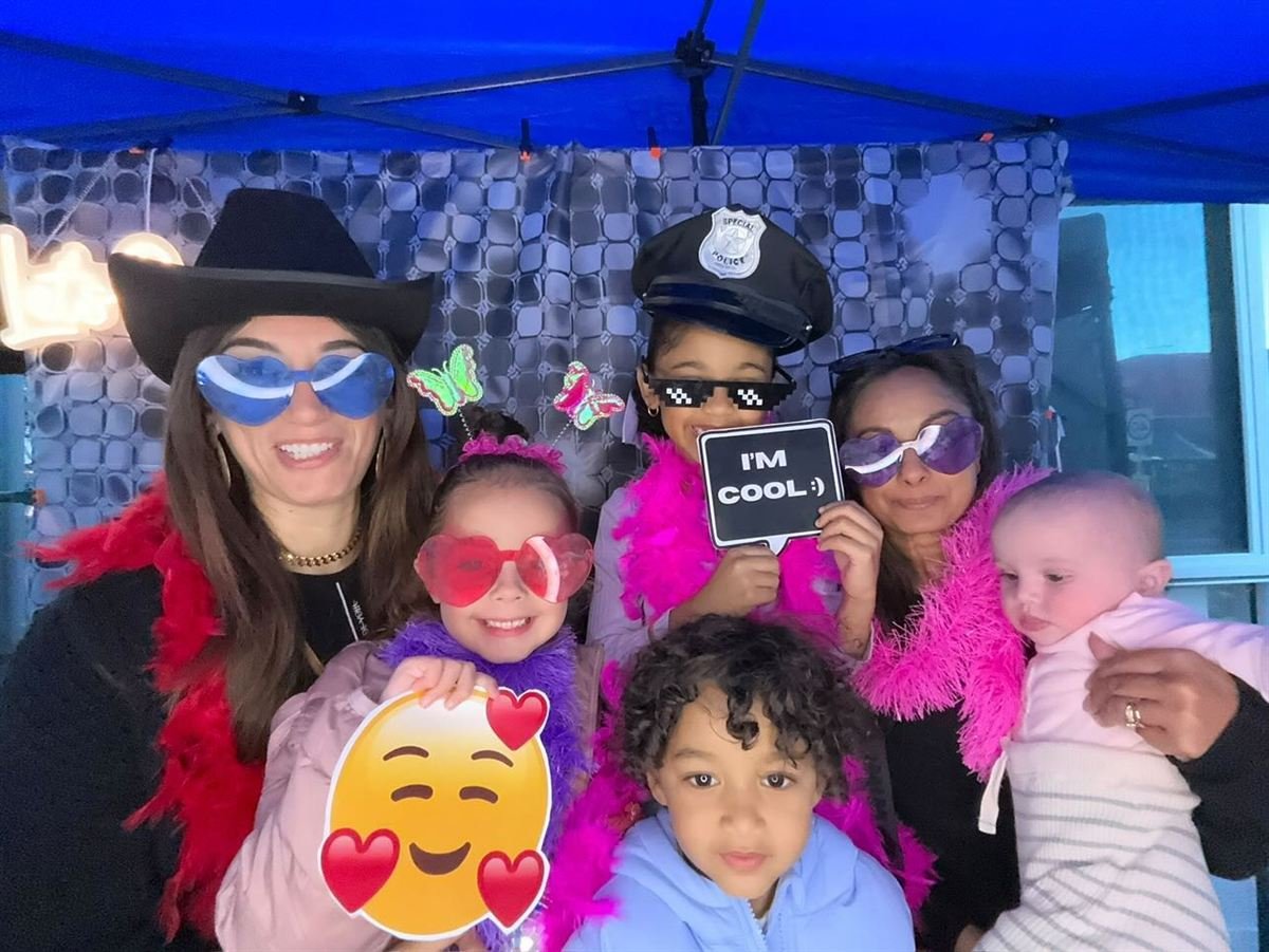 Friends posing with props at Fotobooth Perth